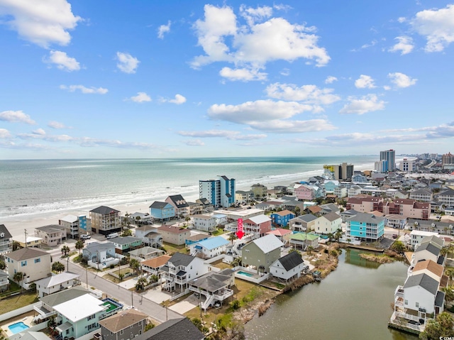 bird's eye view featuring a water view and a beach view