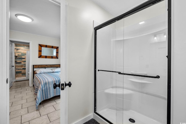 bathroom featuring a shower with shower door and tile patterned flooring