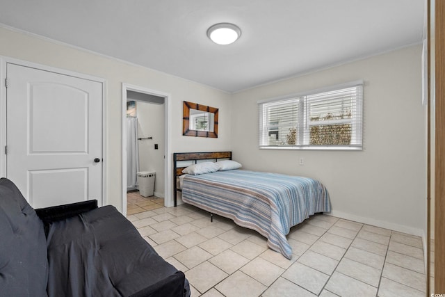 tiled bedroom with ornamental molding and ensuite bathroom