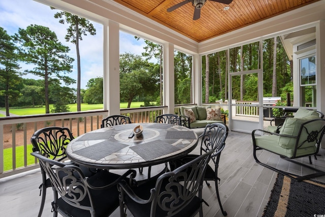 sunroom / solarium with wood ceiling and ceiling fan