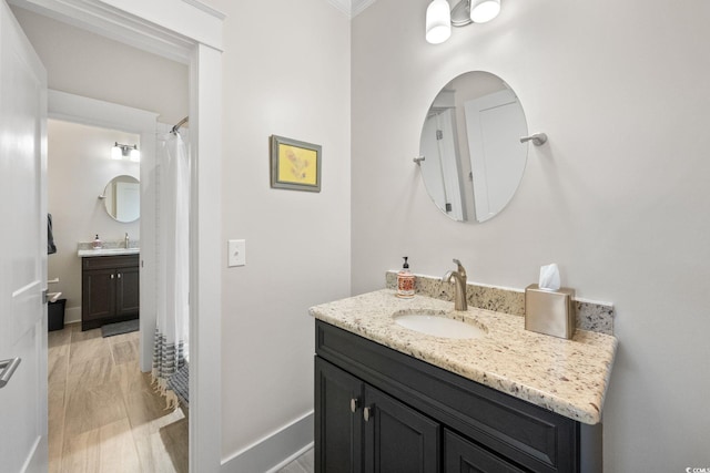 bathroom with vanity, ornamental molding, curtained shower, and hardwood / wood-style floors