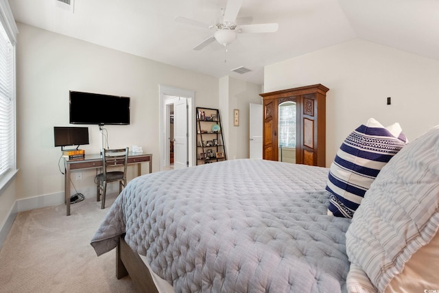 carpeted bedroom featuring vaulted ceiling, multiple windows, and ceiling fan