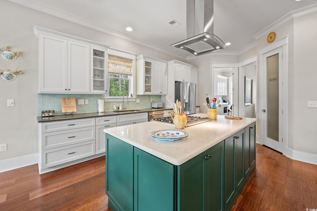 kitchen featuring island exhaust hood, dark wood-type flooring, stainless steel appliances, sink, and white cabinets