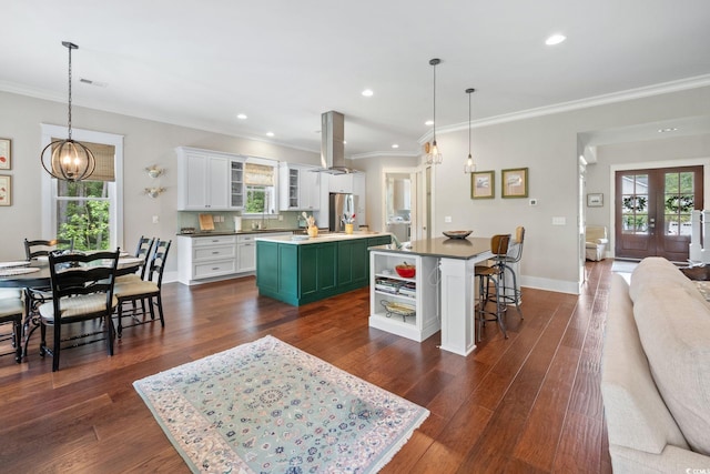 kitchen featuring stainless steel fridge, dark hardwood / wood-style flooring, white cabinetry, island range hood, and a center island