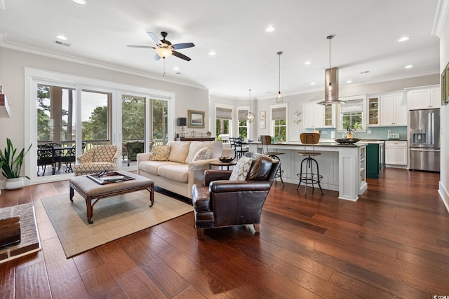 living room with dark wood-type flooring and crown molding