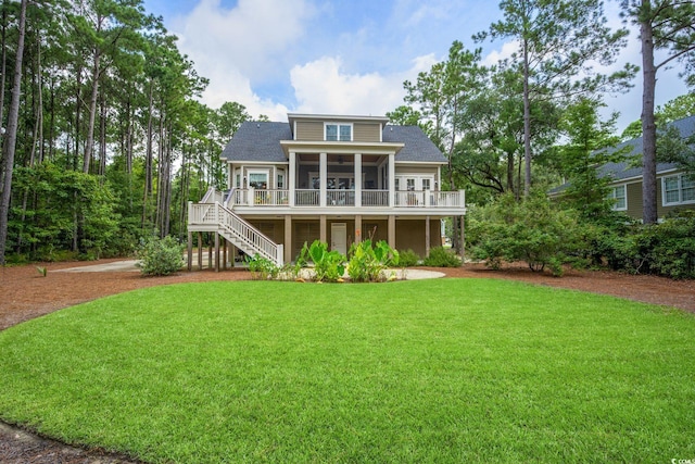 back of property featuring a sunroom and a lawn