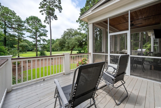 rear view of house with a lawn and a sunroom