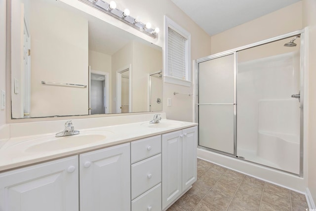 bathroom featuring vanity and a shower with shower door