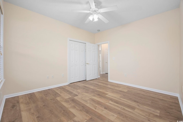 unfurnished bedroom featuring light hardwood / wood-style flooring, ceiling fan, and a closet