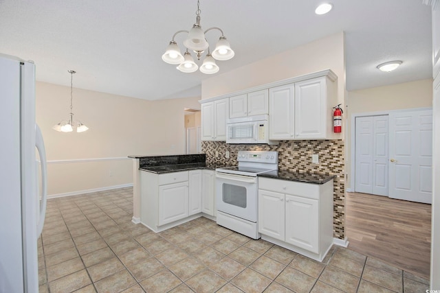 kitchen with light wood-type flooring, white appliances, a chandelier, white cabinetry, and tasteful backsplash