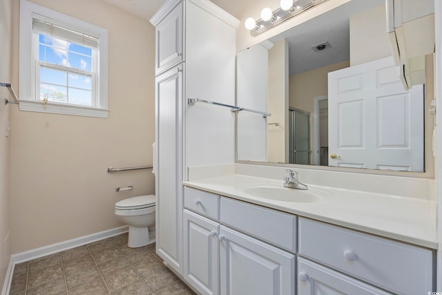 bathroom with tile patterned floors, walk in shower, toilet, and vanity