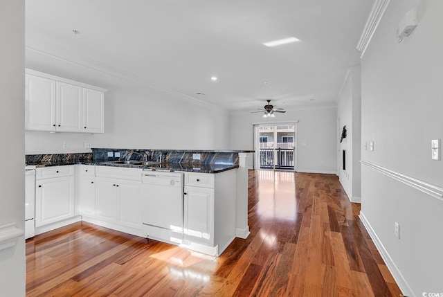 kitchen featuring dishwasher, kitchen peninsula, and white cabinetry