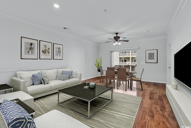 living room featuring ornamental molding, ceiling fan, and hardwood / wood-style floors