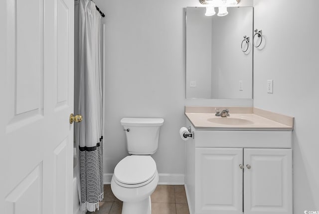 bathroom with a shower with curtain, vanity, toilet, and tile patterned floors