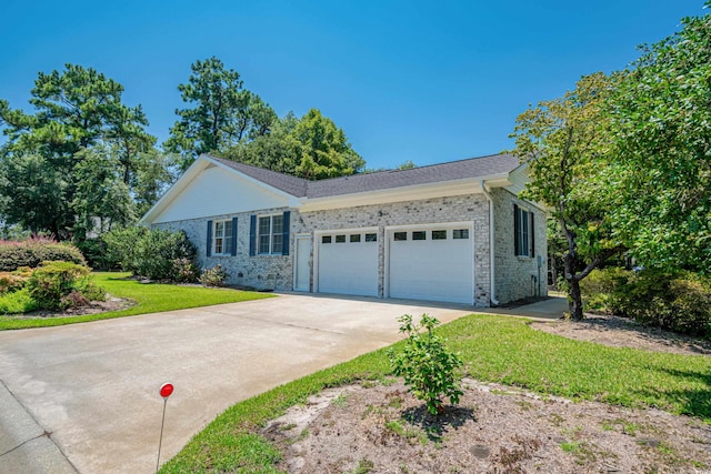 single story home with a garage and a front lawn