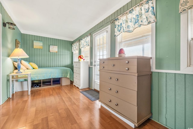 bedroom featuring hardwood / wood-style flooring and ornamental molding