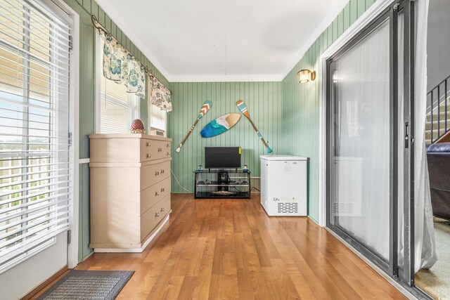 interior space featuring crown molding and wood-type flooring