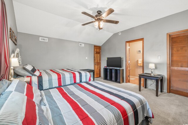 bedroom with connected bathroom, ceiling fan, light carpet, and vaulted ceiling