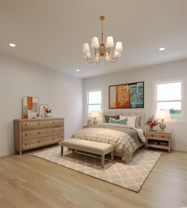 bedroom featuring light hardwood / wood-style flooring and a notable chandelier