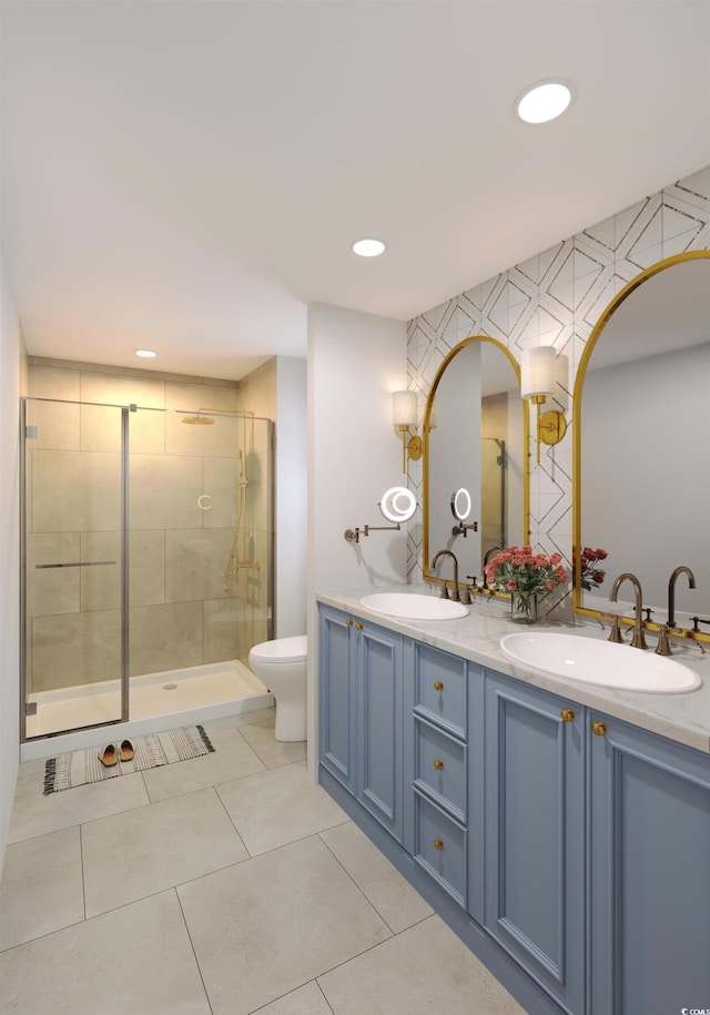 bathroom with tile patterned floors, vanity, toilet, and a shower with shower door