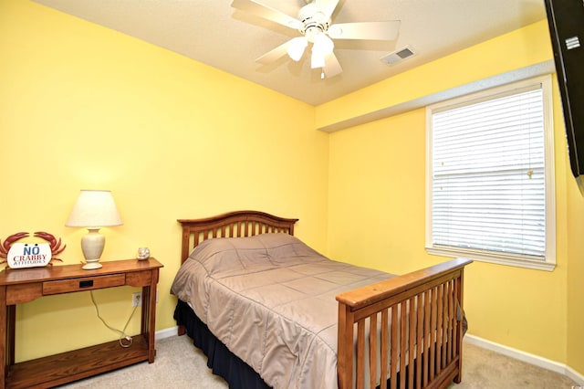 bedroom featuring light carpet and ceiling fan