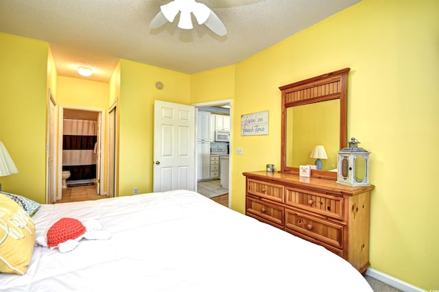 tiled bedroom with a textured ceiling, connected bathroom, ceiling fan, and a closet