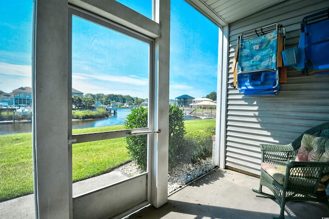 sunroom / solarium with a water view and a wealth of natural light