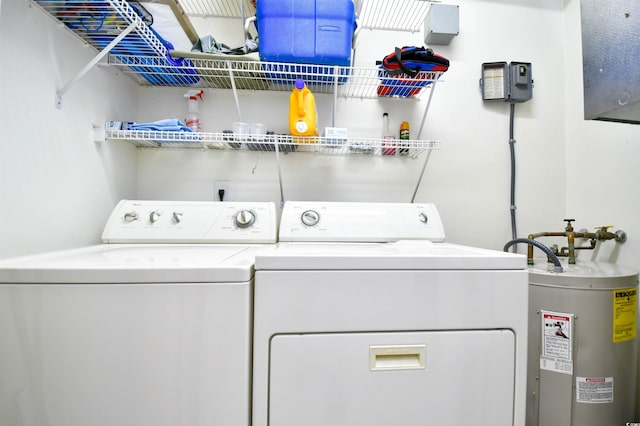 clothes washing area with electric water heater and washer and clothes dryer