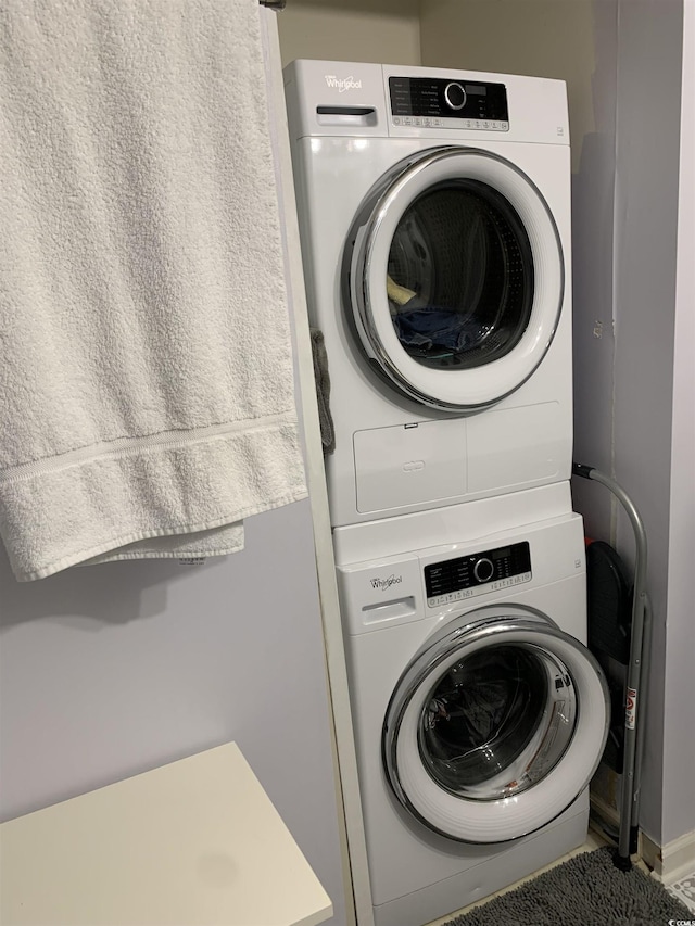 laundry area with stacked washer and clothes dryer