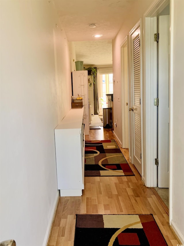 corridor with light wood-type flooring