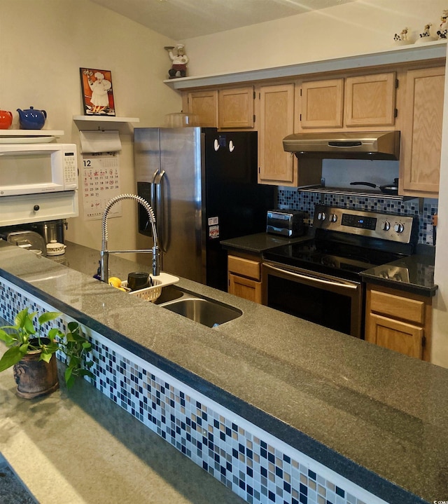 kitchen featuring decorative backsplash, sink, and appliances with stainless steel finishes