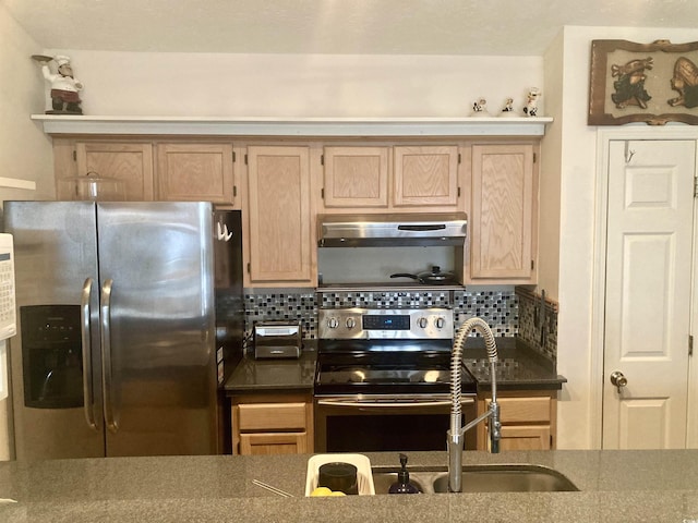 kitchen featuring light brown cabinets, sink, backsplash, and appliances with stainless steel finishes