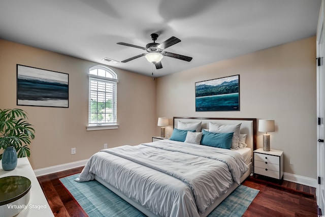 bedroom with dark hardwood / wood-style floors and ceiling fan