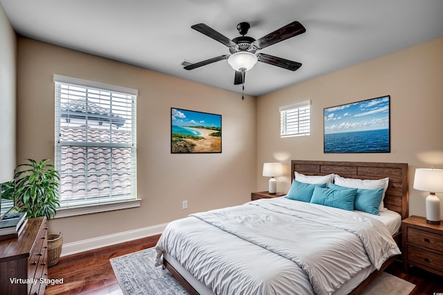 empty room with ceiling fan and dark hardwood / wood-style flooring