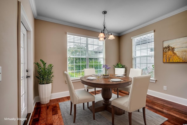 interior space with an inviting chandelier, hardwood / wood-style flooring, and ornamental molding