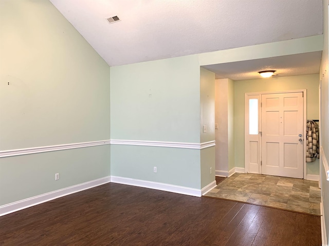 entryway with dark hardwood / wood-style floors and a textured ceiling