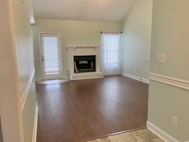 unfurnished living room with a fireplace and hardwood / wood-style floors