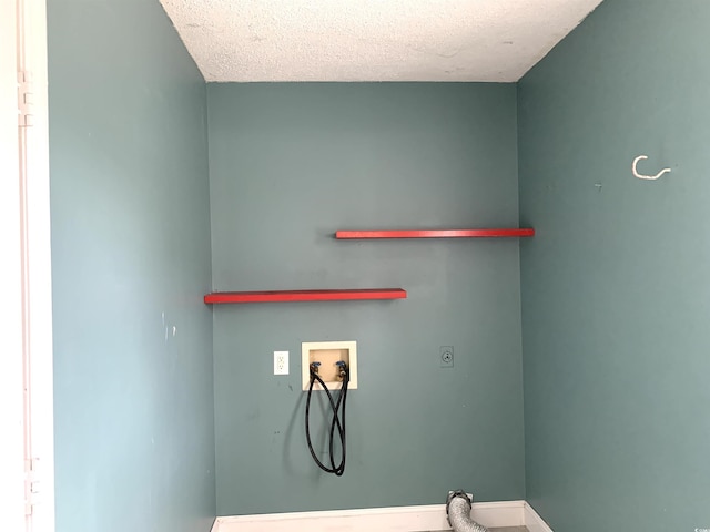 laundry room with hookup for a washing machine, a textured ceiling, and electric dryer hookup