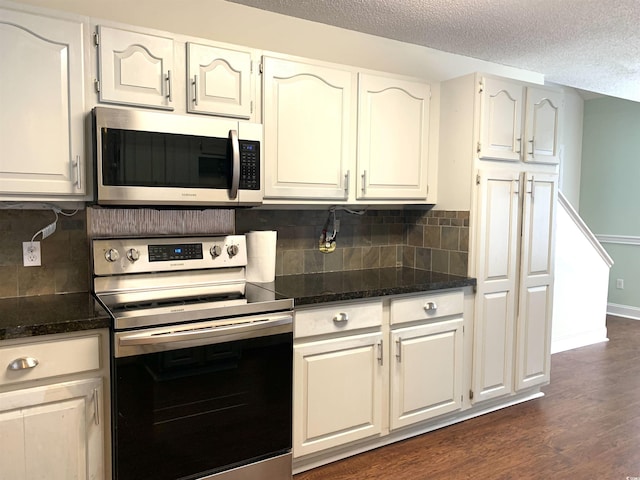 kitchen featuring white cabinetry, appliances with stainless steel finishes, dark hardwood / wood-style flooring, and a textured ceiling