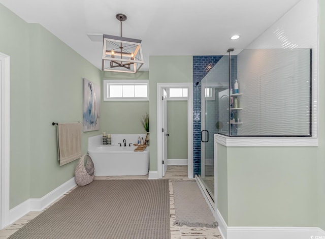 bathroom with shower with separate bathtub and a notable chandelier