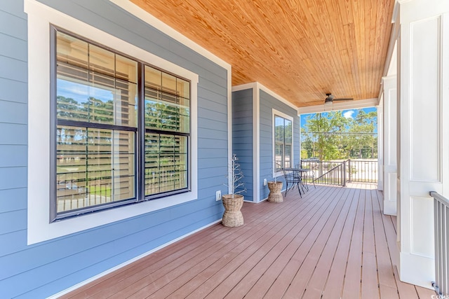 wooden deck featuring ceiling fan and a porch