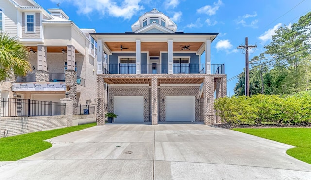 view of front of home featuring a garage, a balcony, and ceiling fan