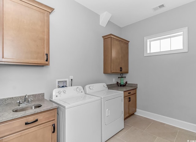 washroom with cabinets, light tile patterned flooring, sink, and independent washer and dryer