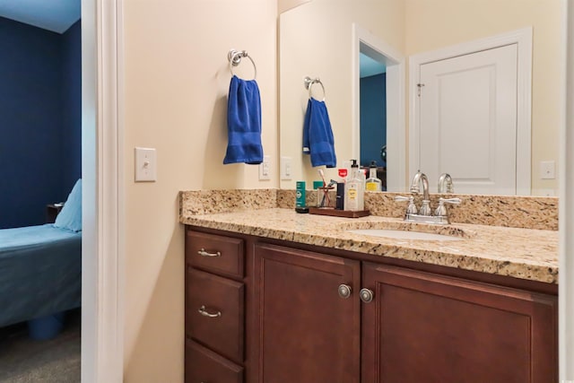 ensuite bathroom with connected bathroom and vanity