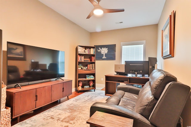 office area featuring baseboards, wood finished floors, visible vents, and a ceiling fan