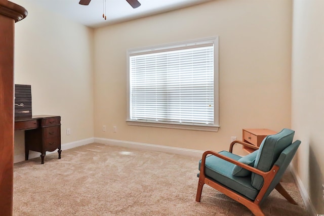 sitting room with carpet floors, a ceiling fan, and baseboards