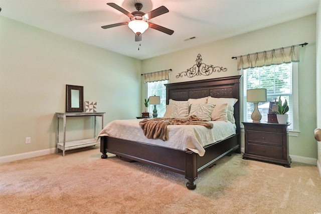 bedroom with carpet, visible vents, ceiling fan, and baseboards