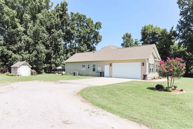 ranch-style house featuring a storage shed, concrete driveway, an outbuilding, cooling unit, and a front lawn