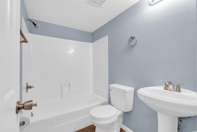 bathroom with toilet, tile patterned floors, and shower / washtub combination