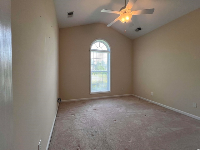 unfurnished room with ceiling fan, vaulted ceiling, and carpet